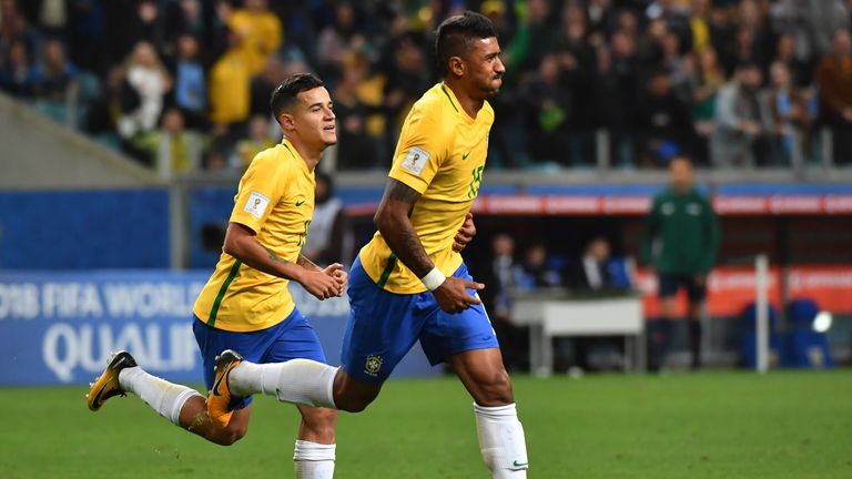 Paulinho celebrates with Brazilian team-mate Coutinho after scoring against Ecuador