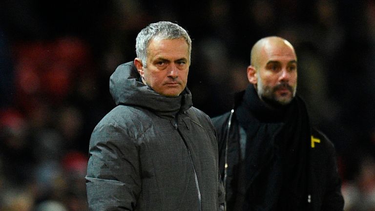 Manchester United's Portuguese manager Jose Mourinho (L) and Manchester City's Spanish manager Pep Guardiola (R) watch from the touchline during the Englis
