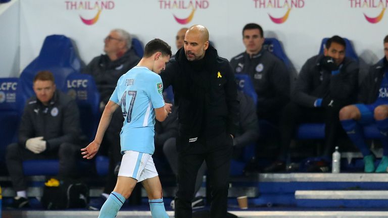 Pep Guardiola talks with Phil Foden as he leaves the pitch during the Carabao Cup Quarter-Final at the King Power Stadium