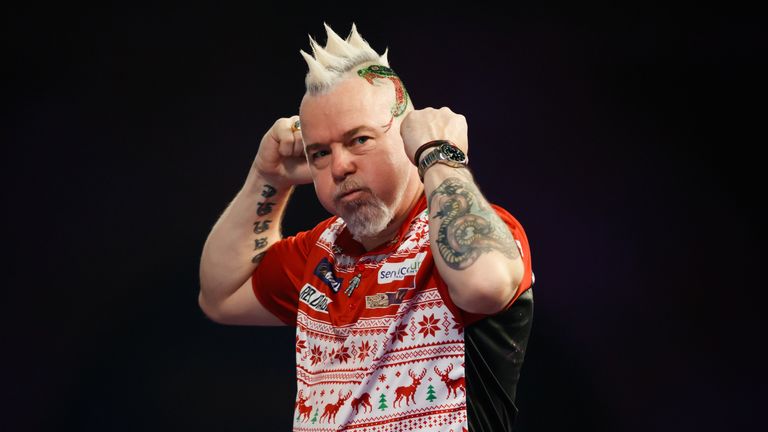 Peter Wright celebrates his victory against Diogo Portela on day eight of the William Hill World Darts Championship