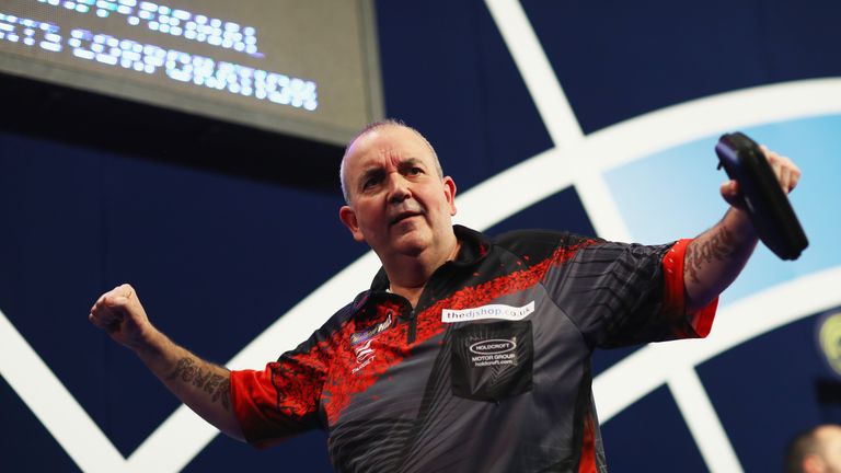 LONDON, ENGLAND - DECEMBER 23:  Phil Taylor of England celebrates after winning the second round match against Justin Pipe of England on day ten of the 201