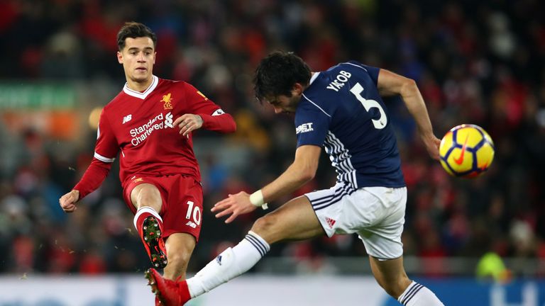 LIVERPOOL, ENGLAND - DECEMBER 13: Philippe Coutinho of Liverpool shoots as Claudio Yacob of Wes Bromwich Albion attempts to block during the Premier League