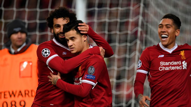 Liverpool's Brazilian midfielder Philippe Coutinho (C) celebrates scoring their fifth goal and completing his hattrick with Liverpool's Egyptian midfielder