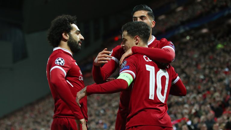 LIVERPOOL, ENGLAND - DECEMBER 06:  Philippe Coutinho of Liverpool celebrates after scoring his sides second goal with team mates during the UEFA Champions 