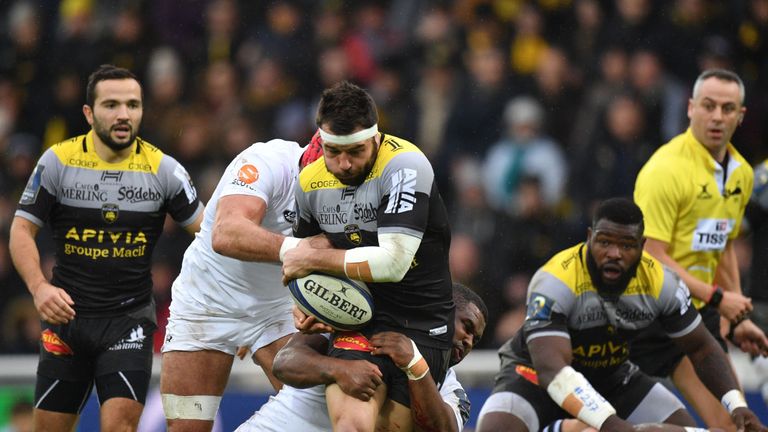 La Rochelle's French centre Pierre Aguillon (C) runs with the ball during the European Rugby Champions Cup rugby union match between La Rochelle and Wasps 