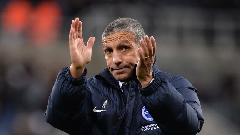 Chris Hughton applauds fans after the Premier League match against Newcastle United