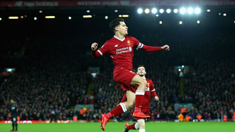 Philippe Coutinho scores his sides first goal during the Premier League match between Liverpool and Swansea