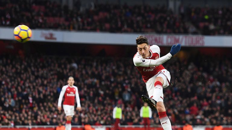 Mesut Ozil hits a left-footed volley to put Arsenal in front at the Emirates Stadium
