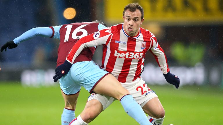 Xherdan Shaqiri holds off a challenge from Steven Defour