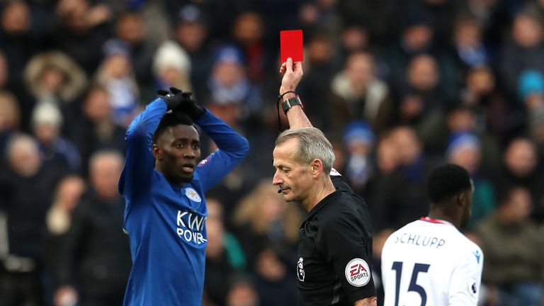 Wilfred Ndidi is shown a red card by referee Martin Atkinson after receiving his second booking