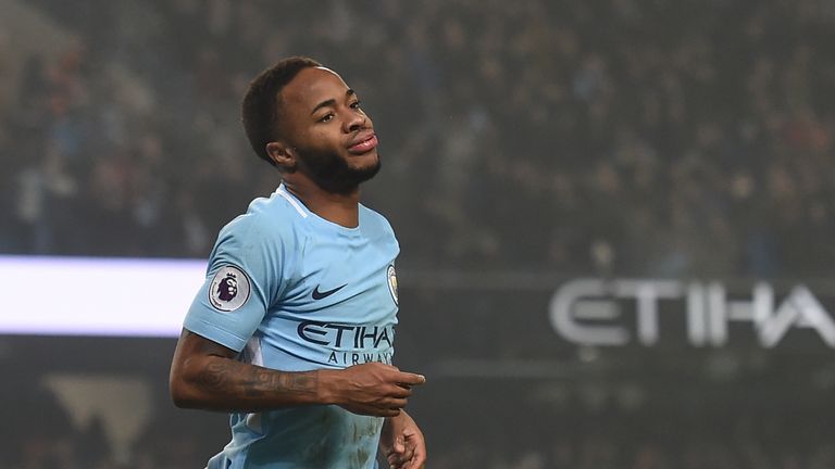 Raheem Sterling celebrates after scoring City's third