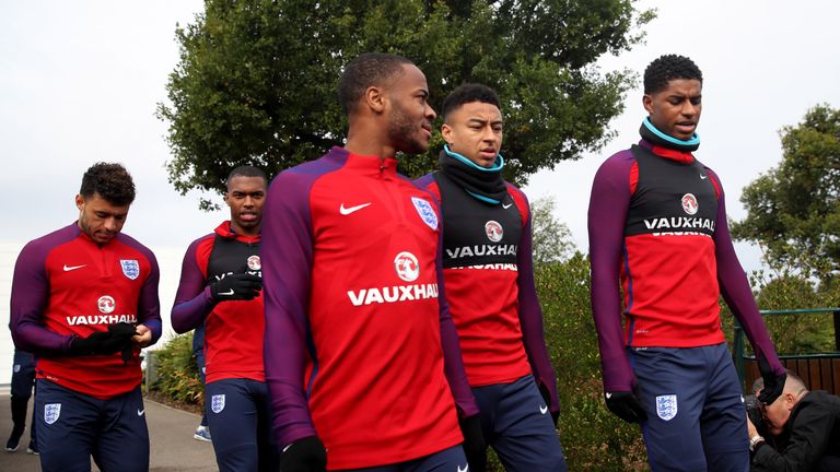 Raheem Sterling of Man City, Jesse Lingard of Man United and Marcus Rashford of Man United walk out to an England training session