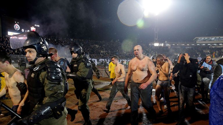 Policemen arrest Partizan Belgrade's hooligans after clashes between two groups of Partizan Belgrade's supporters during the Serbian Superleague derby foot