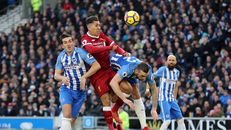 Liverpool's Roberto Firmino (centre) battles for the ball with Brighton & Hove Albion's Lewis Dunk (left) and Shane Duffy during the Premier League match a