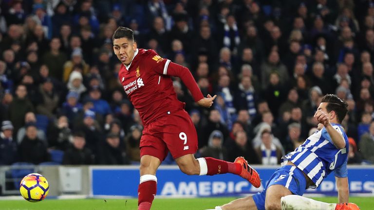 BRIGHTON, ENGLAND - DECEMBER 02: Roberto Firmino of Liverpool scores his sides third goal as Lewis Dunk of Brighton and Hove Albion attempts to block durin