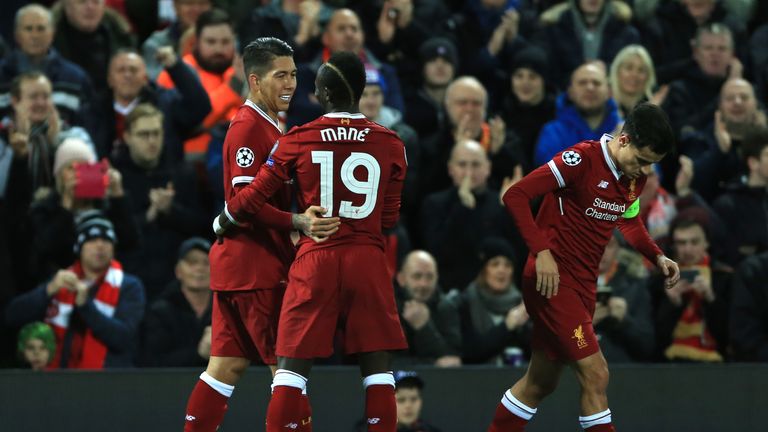 Liverpool's Roberto Firmino (left) celebrates scoring his sides third goal of the game during the UEFA Champions League, Group E match at Anfield, Liverpoo