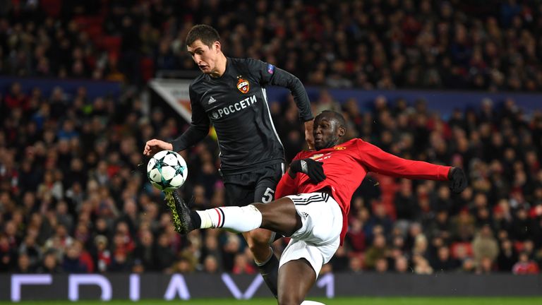 MANCHESTER, ENGLAND - DECEMBER 05: Romelu Lukaku of Manchester United scores his sides first goal while under pressure from Viktor Vasin of CSKA Moscow dur