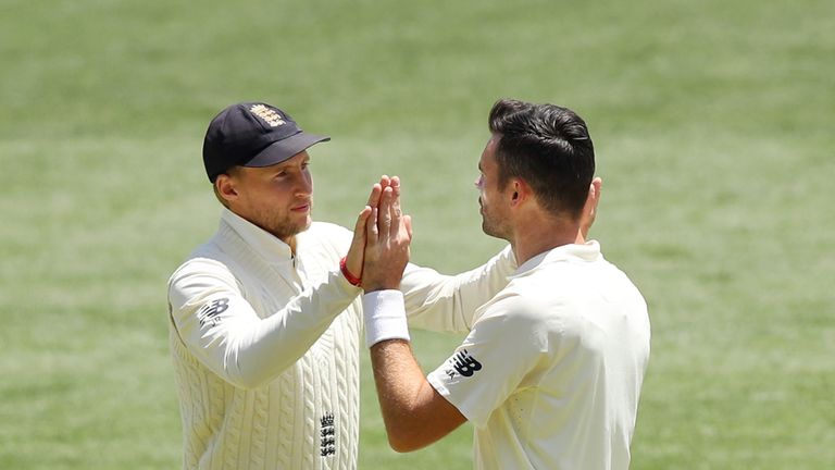 ADELAIDE, AUSTRALIA - DECEMBER 05: Joe Root of England congratulates team mate James Anderson after dismissing Nathan Lyon of Australia during day four of 