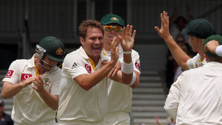 Australian fast bowler Ryan Harris (C) celebrates with teammates after taking six wickets for the innings on the fourth day the third Ashes cricket Test ma