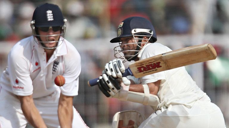 England cricketer Alastair Cook (L) looks on as Indian cricketer Sachin Tendulkar plays a shot on the fifth and final day of the first Test between India a