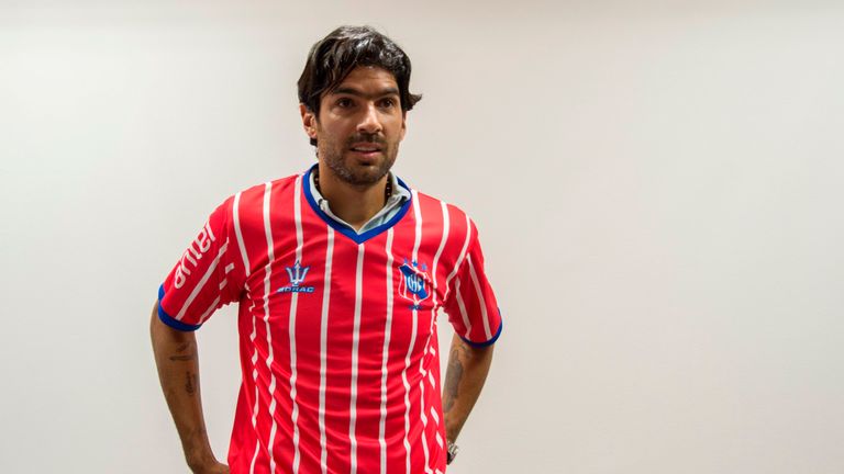 Uruguayan footballer Sebastian "loco" Abreu, 40,  shows his jersey as he is presented as Uruguay's second division Central Espanol FC new player, in Montev