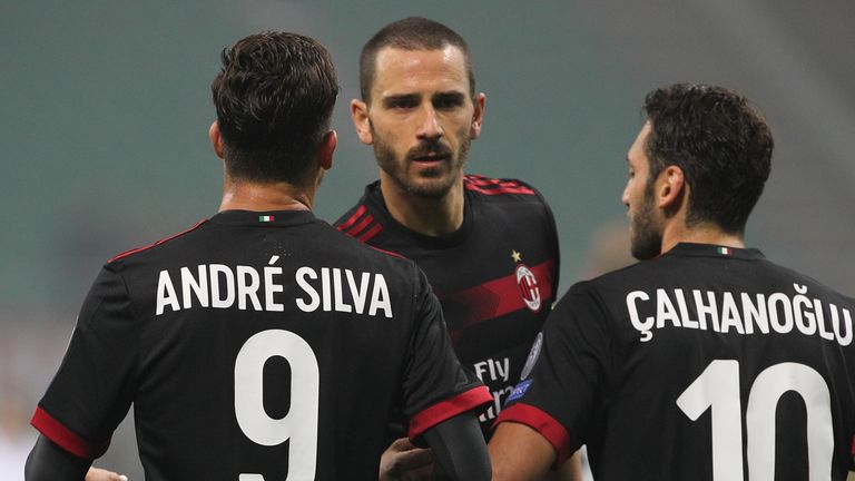 MILAN, ITALY - NOVEMBER 23:  Andre Silva (L) of AC Milan celebrates his goal with his team-mates Leonardo Bonucci (C) and Hakan Calhanoglu (R) during the U