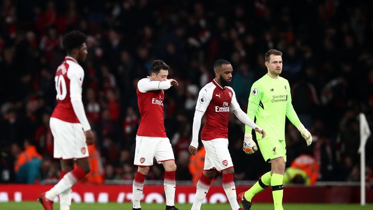 Arsenal's Mesut Ozil (centre left) walks off dejected at half time during the Premier League match at the Emirates Stadium, London