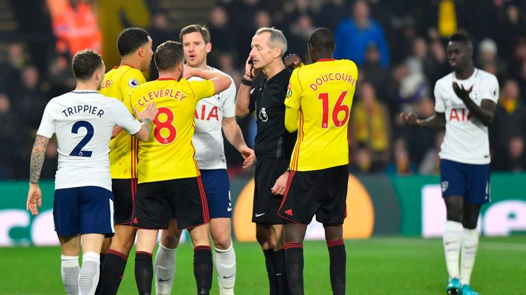 Players surround referee Martin Atkinson (C) after he sent off Tottenham Hotspur's Davinson Sanchez (R)