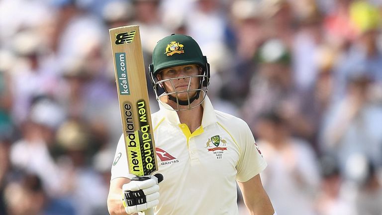 Steve Smith raises hit bat after reaching 50