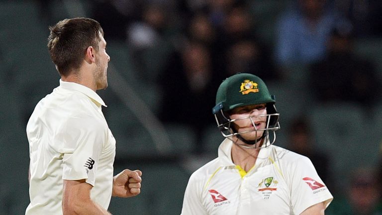 England's paceman Chris Woakes celebrates dismissing Australia's batsman Steve Smith (R) on the third day of the second Ashes Test in Adelaide