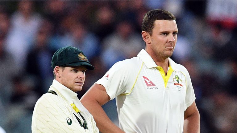 Australia's captain Steve Smith (L) and paceman Josh Hazlewood watch on the big screen a review of a decision against an England batsman on the fourth day 