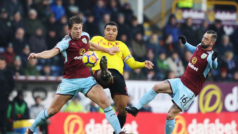 Troy Deeney is challenged by James Tarkowski