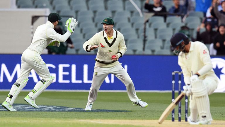 Australia's Peter Handscomb (C) celebrates with teammate Tim Paine (L) after taking a catch to dismiss England's batsman James Vince (R) on the fourth day 