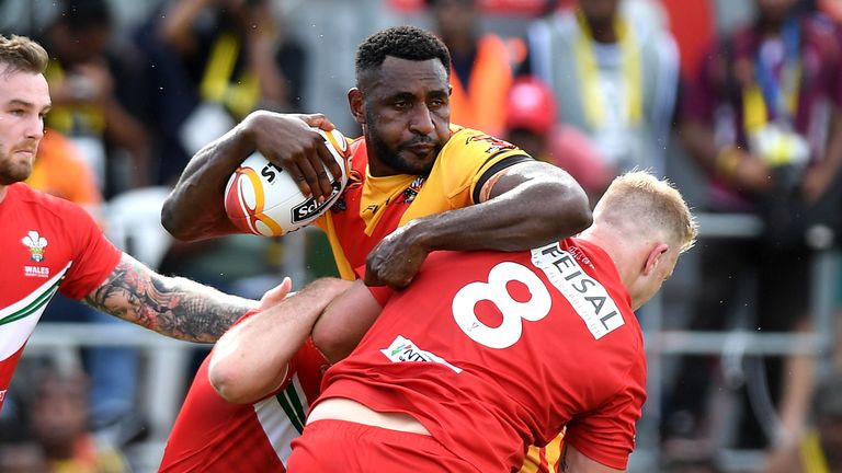 Wellington Albert of Papua New Guinea is tackled during the Rugby League World Cup match against Wales
