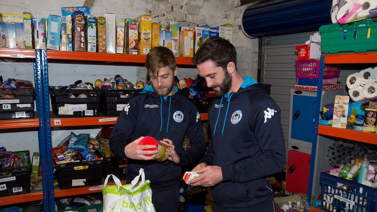 Wigan pair Michael Jacobs and Will Grigg prepare food parcels 