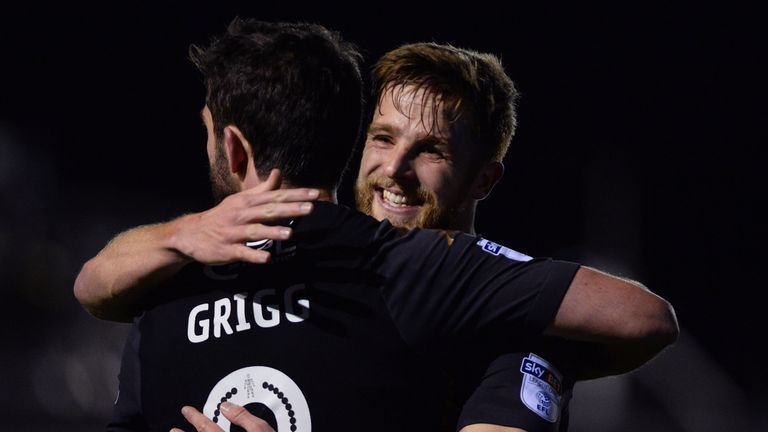 KIRKHAM, ENGLAND - DECEMBER 01: Will Grigg hugs Michael Jacobs of Wigan Athletic after he scores during The Emirates FA Cup Second Round match between AFC 