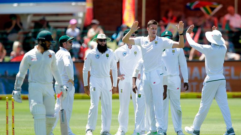 South African bowler Morne Morkel (2R) celebrates with teammmates after the dismissal of Zimbabwean batsman Ryan Burl (L) during the second day of the day 