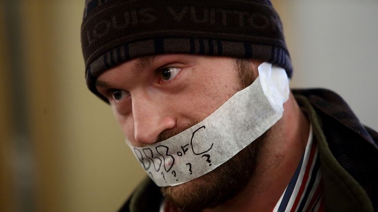 LONDON, ENGLAND - SEPTEMBER 22:  Tyson Fury with tape over his mouth after refusing to speak during the Dereck Chisora And Tyson Fury Press Conference at T