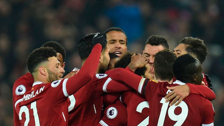 Liverpool's Egyptian midfielder Mohamed Salah (C) celebrates scoring their fourth goal to make the score 4-1 with team-mates during the English Premier Lea