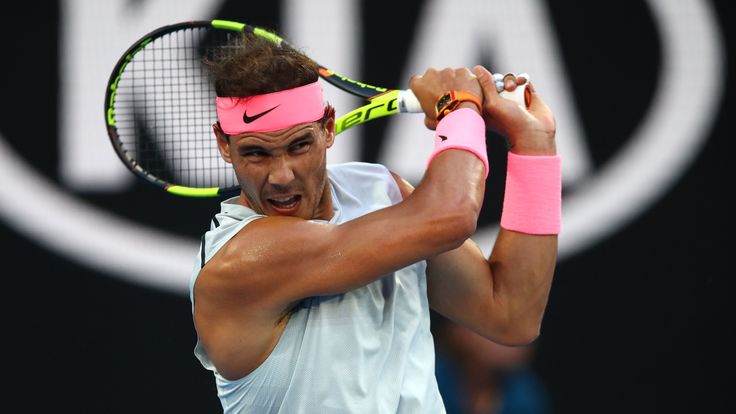 MELBOURNE, AUSTRALIA - JANUARY 15:  Rafael Nadal of Spain plays a backhand in his first round match against Victor Estrella Burgos of the Dominican Republi