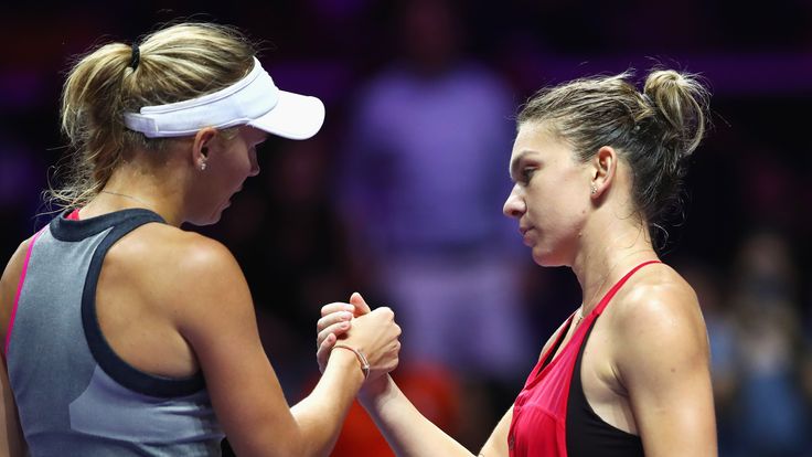 SINGAPORE - OCTOBER 25:  Caroline Wozniacki (L) of Denmark celebrates victory as she shakes the hand of Simona Halep of Romania after their singles match d