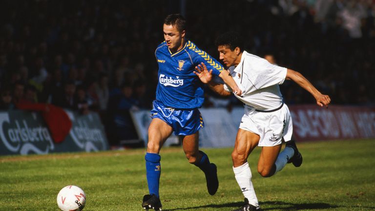 Tottenham defender Chris Hughton challenges Wimbledon player Dennis Wise during a League Division One match in 1989