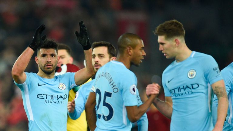 Manchester City striker Sergio Aguero (L) applauds the crowd at the end of the English Premier League football match against Liverpool