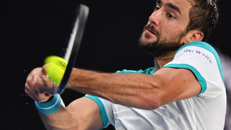 Croatia's Marin Cilic plays a backhand return to Britain's Kyle Edmund during their men's singles semi-finals match on day 11 of the Australian Open tennis