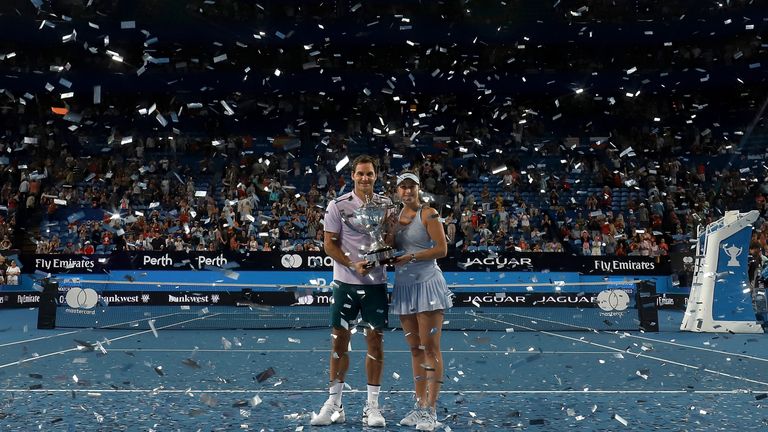 PERTH, AUSTRALIA - JANUARY 06:  Roger Federer and Belinda Bencic of Switzerland pose with the Hopman Cup trophy after defeating Alexander Zverev and Angeli