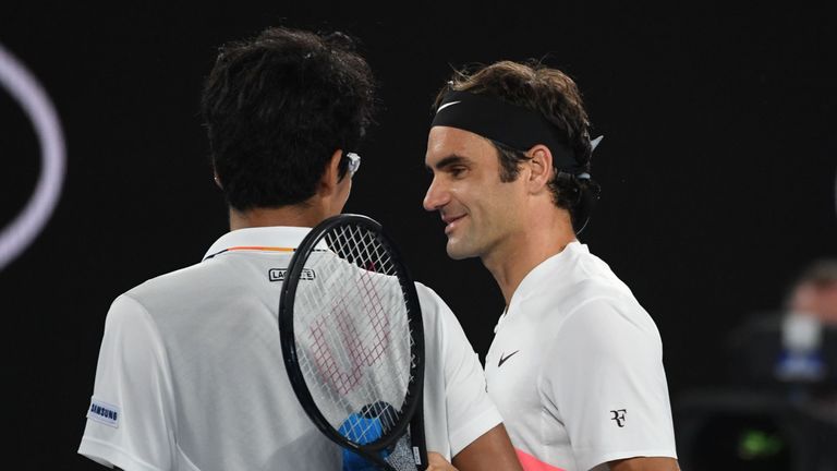 Switzerland's Roger Federer (R) talks to South Korea's Chung Hyeon after Chung retired from their men's singles semi-finals match on day 12 of the Australi