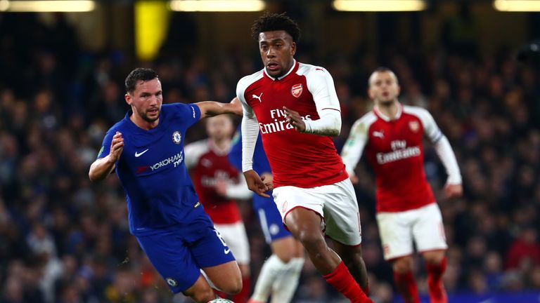 LONDON, ENGLAND - JANUARY 10:  Alex Iwobi of Arsenal runs past Danny Drinkwater of Chelsea  during the Carabao Cup Semi-Final First Leg match between Chels