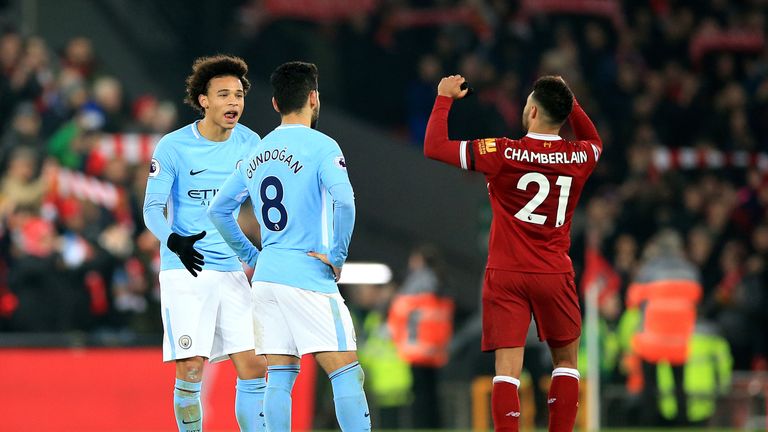 Manchester City's Leroy Sane (left) and Manchester City's Ilkay Gundogan (centre) appear dejected as Liverpool's Alex Oxlade-Chamberlain celebrates after t
