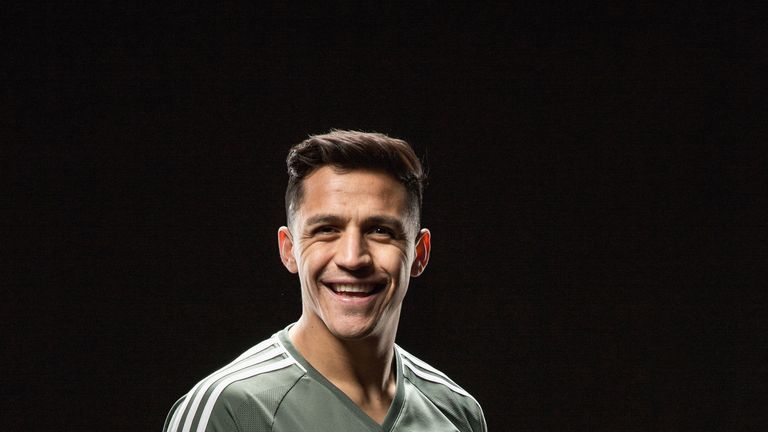 Alexis Sanchez poses after signing for Manchester United at Old Trafford on January 22, 2018