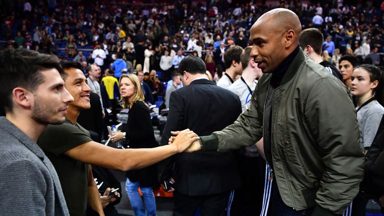 Alexis Sanchez and Thierry Henry shake hands at the NBA match between Indiana Pacers and Denver Nuggets at the O2 Arena last year